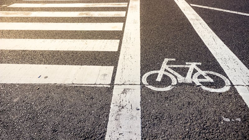 Bike lane symbol with crosswalk on asphalt street