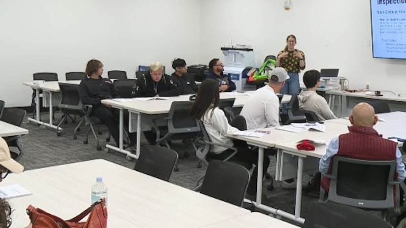 Olivia Alexander-Leeder, a senior registered environmental health specialist, speaks to...