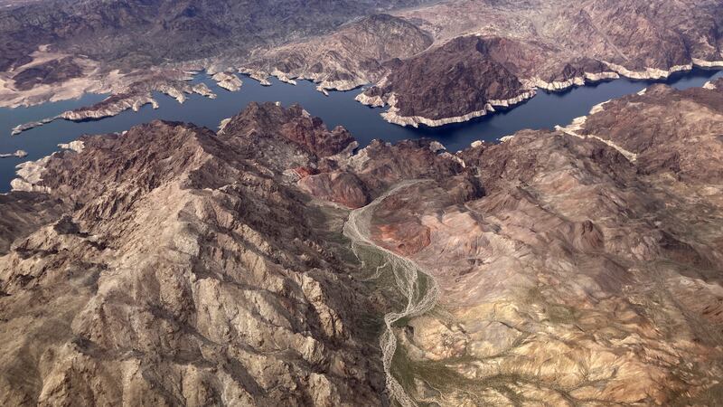 In this aerial photo, a bathtub ring of light minerals show the high water mark on the shore...