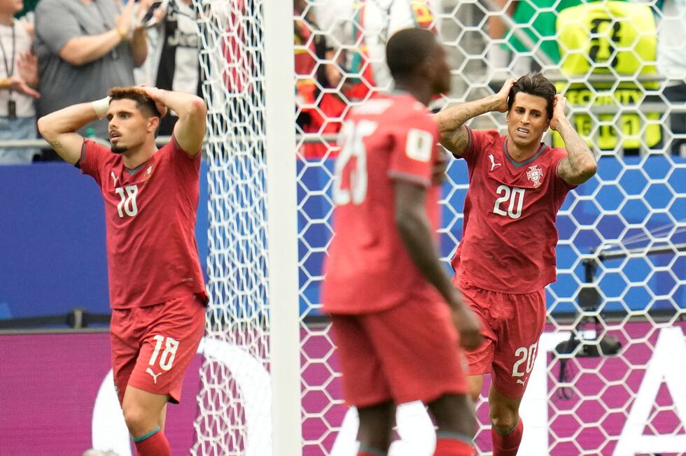 Los portugueses Pedro Neto (izquierda) y Joao Cancelo reaccionan durante el partido contra...