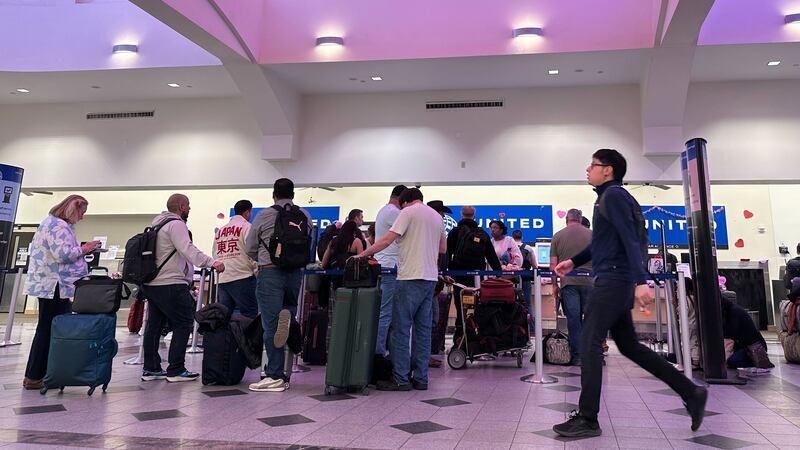 People stand in line at check-in counters at El Paso International Airport, Wednesday, Feb....