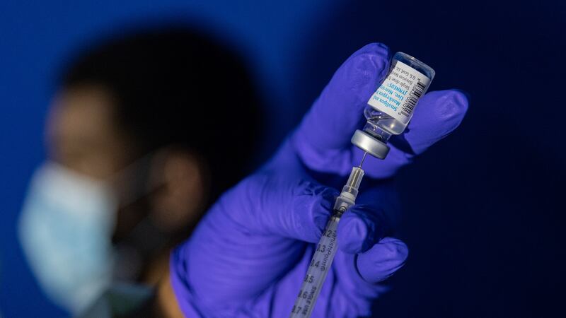 FILE - A family nurse practitioner prepares a syringe with the Mpox vaccine for inoculating a...
